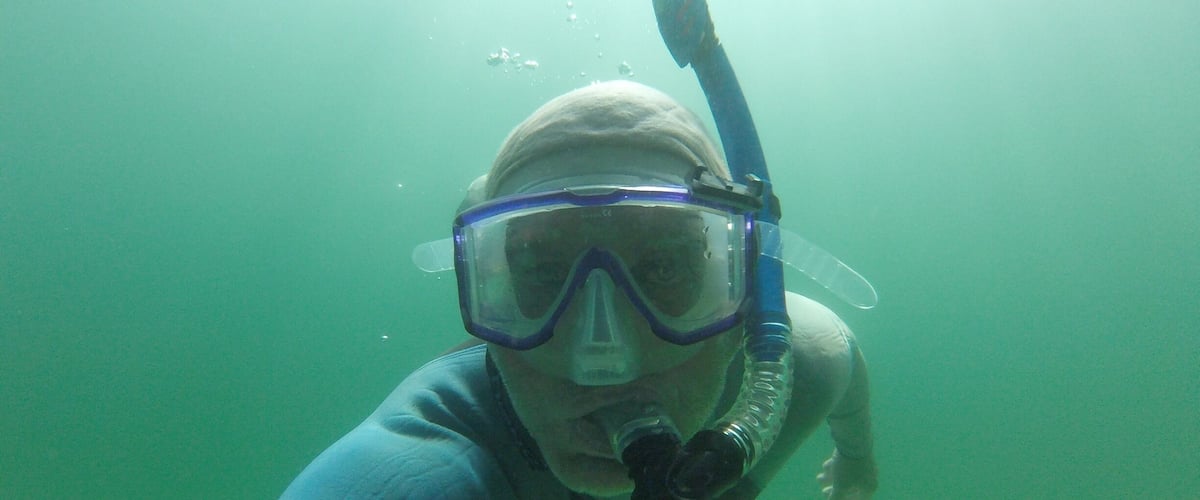 A person snorkeling underwater.