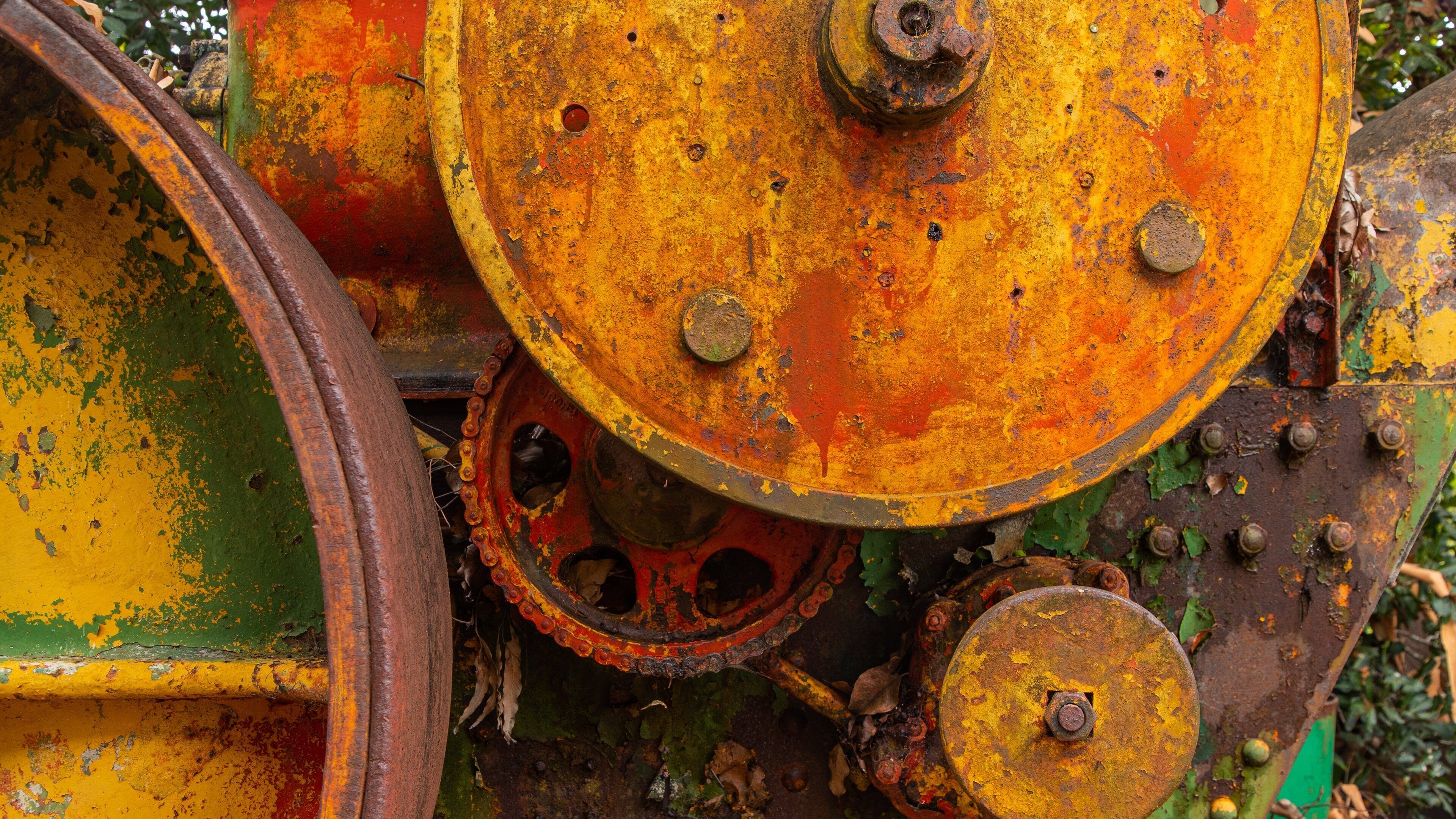 A rusted mechanical part with a chain and bolts.