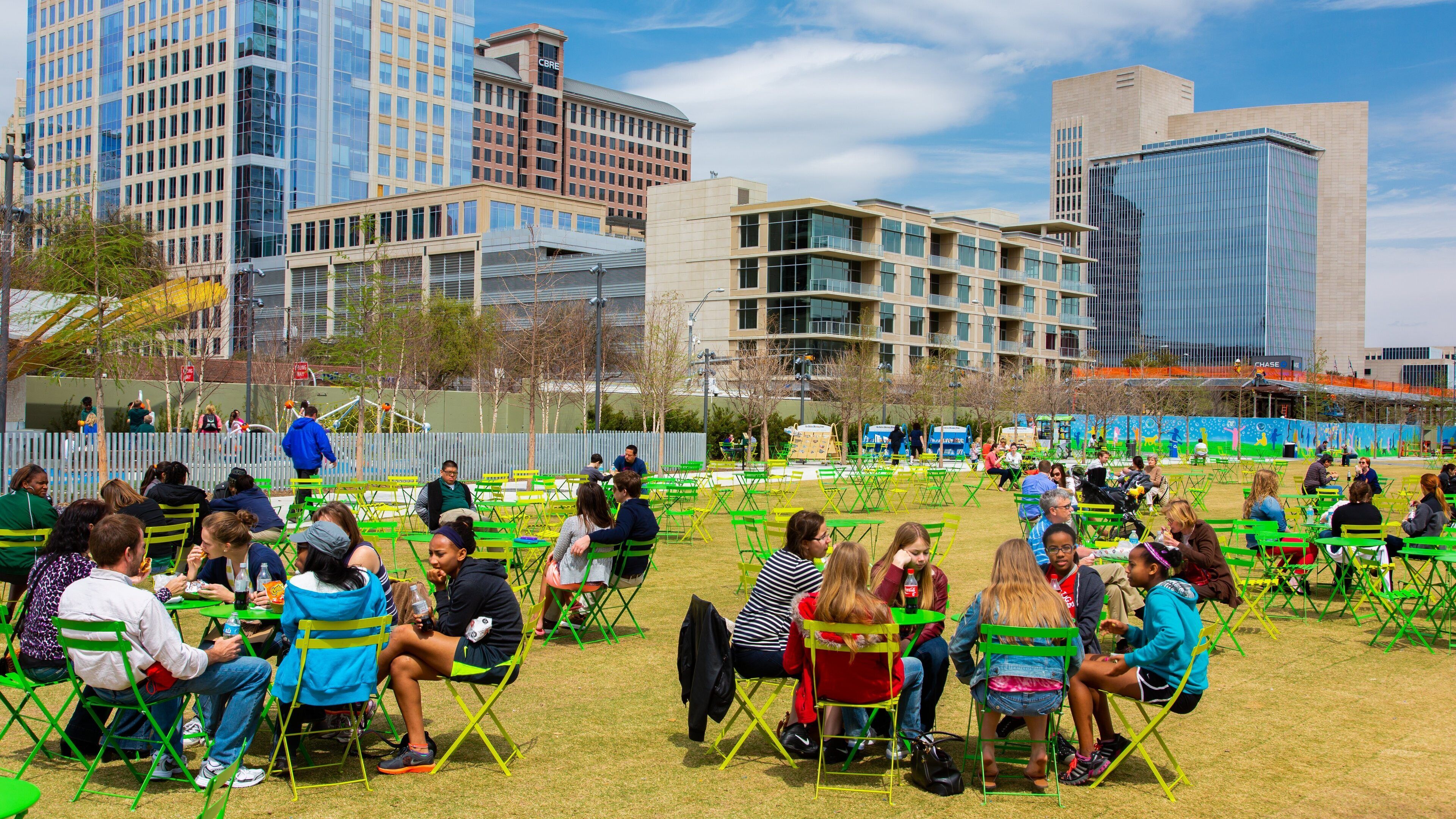 Dallas which includes outdoor eating and a city as well as a small group of people