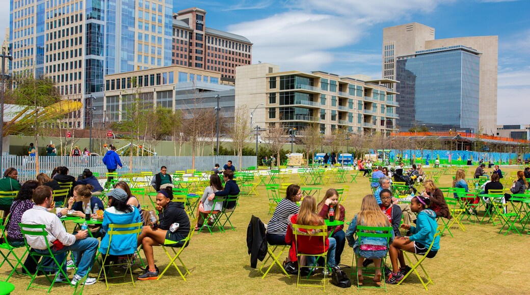 Dallas which includes outdoor eating and a city as well as a small group of people