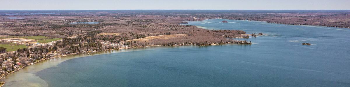 Cumberland beach amigo beach water drone view islands in Ontario Canada summer time blue skies