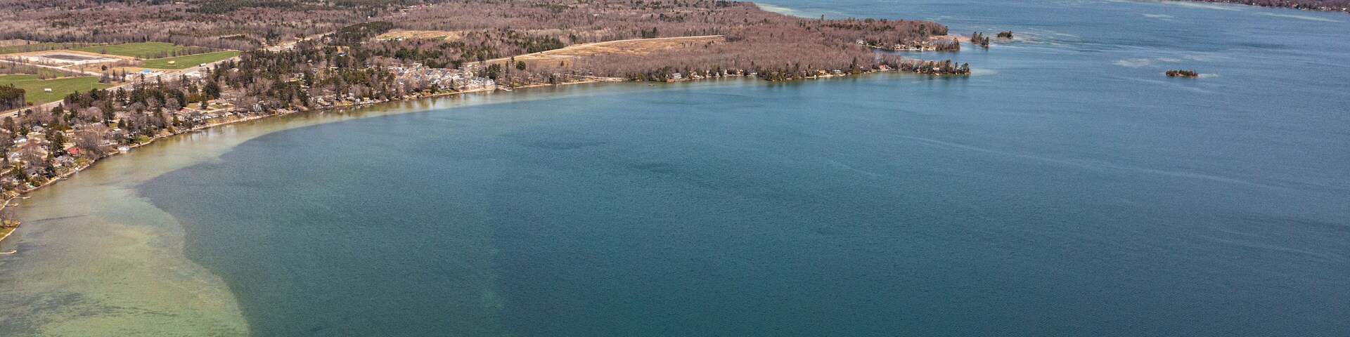 Cumberland beach amigo beach water drone view islands in Ontario Canada summer time blue skies