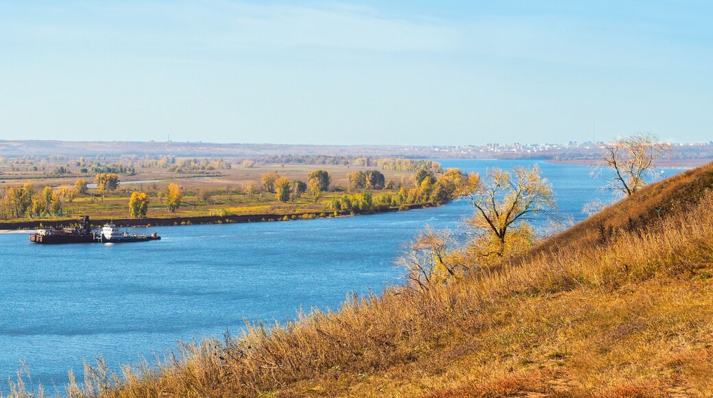 Autumn river landscape from a high hill, Kama river, tug with barge. Nizhnekamsk, Russia