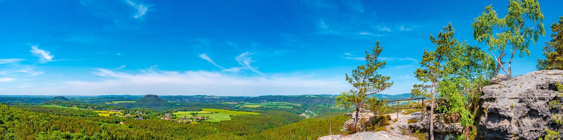 Panoramic over sandstone rocks Gohrisch Stein, Koenigstein and Lilienstein viewed from Papststein and top bird view at the hiking trail in the national park Saxon Switzerland, Bad Schandau, Germany.