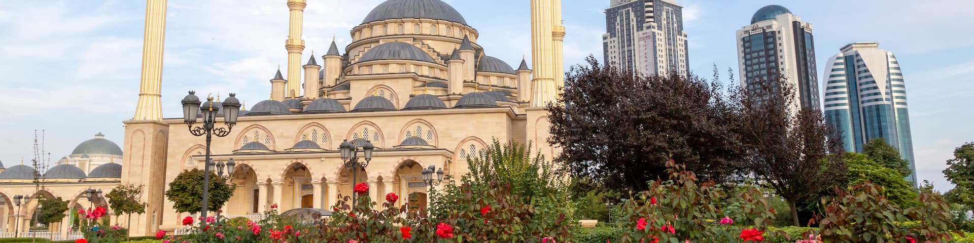 Grozny, Russia: 10.07.2015. Daily life in Chechen Republic. Main mosque of the Chechen Republic - Akhmad Kadyrov Mosque (Heart of Chechnya) and and skyscrapers of Grozny-city