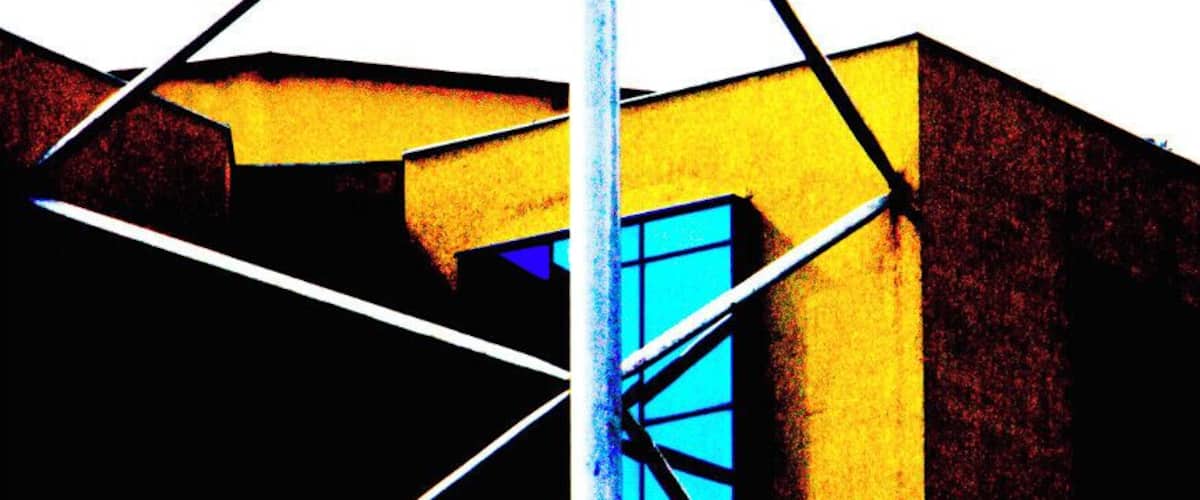 A building with a yellow facade and a blue window.