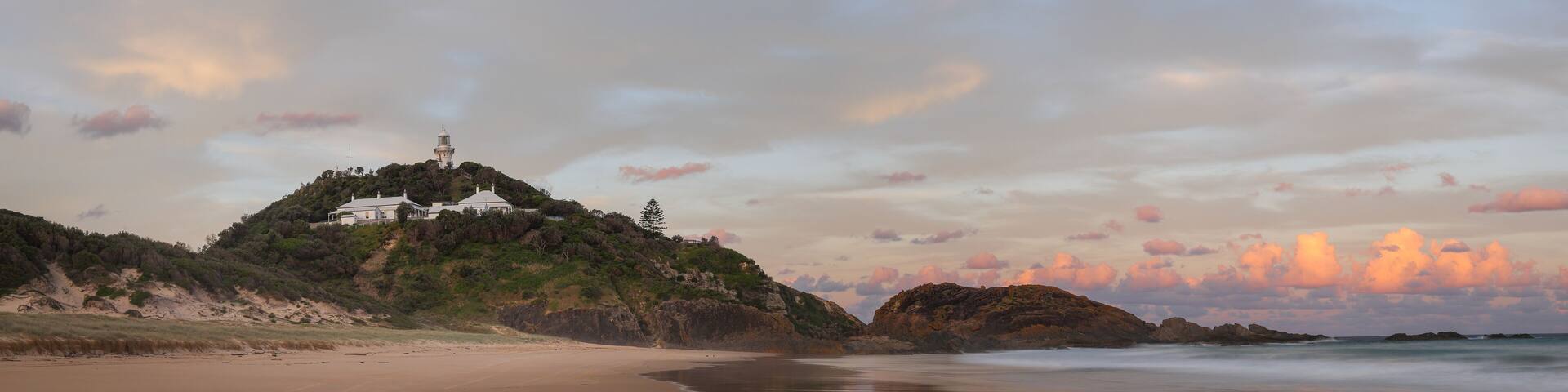 sunset panoramic long exposure shot of sugarloaf point beach and lighthouse at seal rocks in nsw, australia