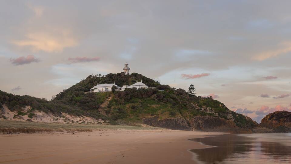 sunset panoramic long exposure shot of sugarloaf point beach and lighthouse at seal rocks in nsw, australia