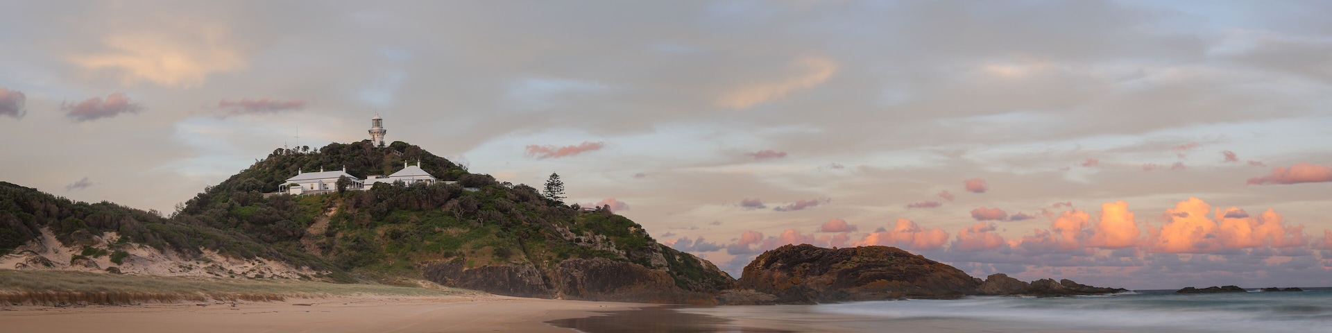sunset panoramic long exposure shot of sugarloaf point beach and lighthouse at seal rocks in nsw, australia