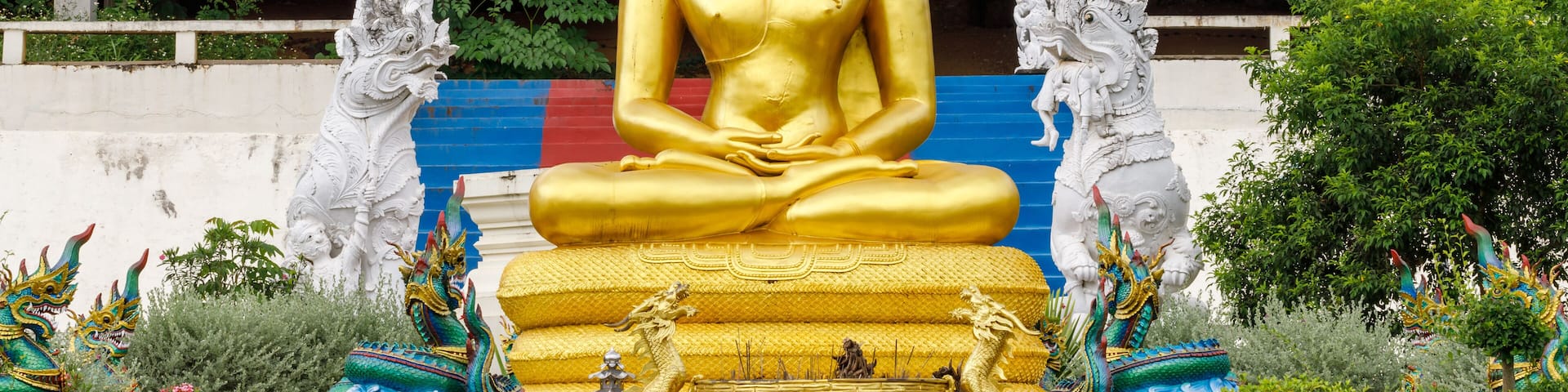Golden Naga 7-headed Buddha image sitting in front of Wat Phra That Suthon Mongkhon Khiri, Den Chai District, Phrae Province, Thailand.
