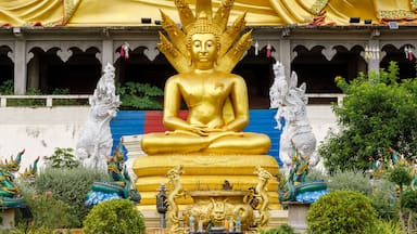 Golden Naga 7-headed Buddha image sitting in front of Wat Phra That Suthon Mongkhon Khiri, Den Chai District, Phrae Province, Thailand.