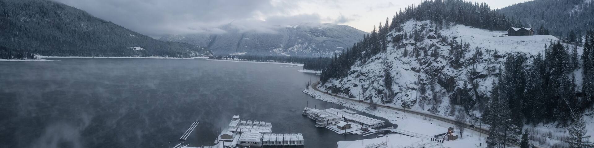 Striking aerial panoramic Canadian Mountain Landscape during a winter morning. Taken at Mara Lake near Sicamous, British Columbia, Canada.