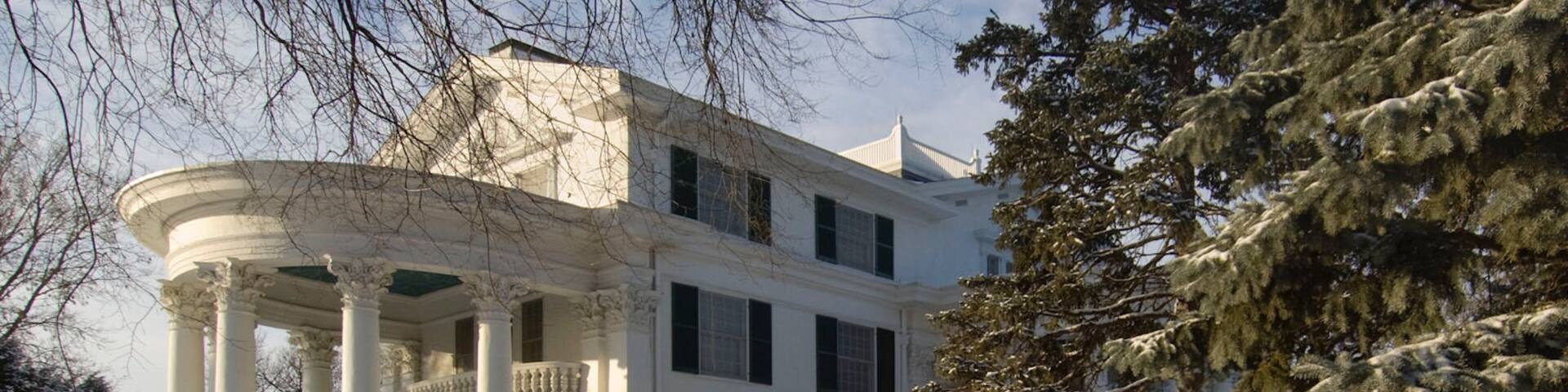 Arbor Lodge State Historical Park showing snow and heritage architecture as well as an individual male