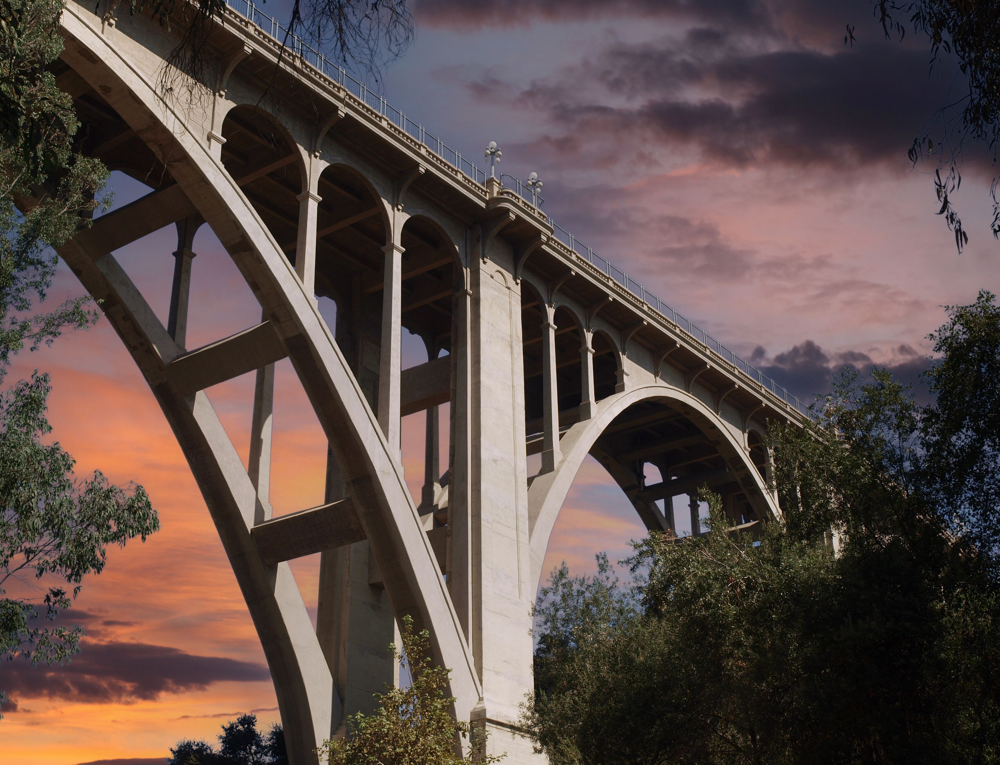 Historic Colorado Boulevard Bridge in Pasadena California with sunset sky.