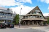 A building with a curved facade and a triangular roof, labeled "Whistler Visitor Centre."