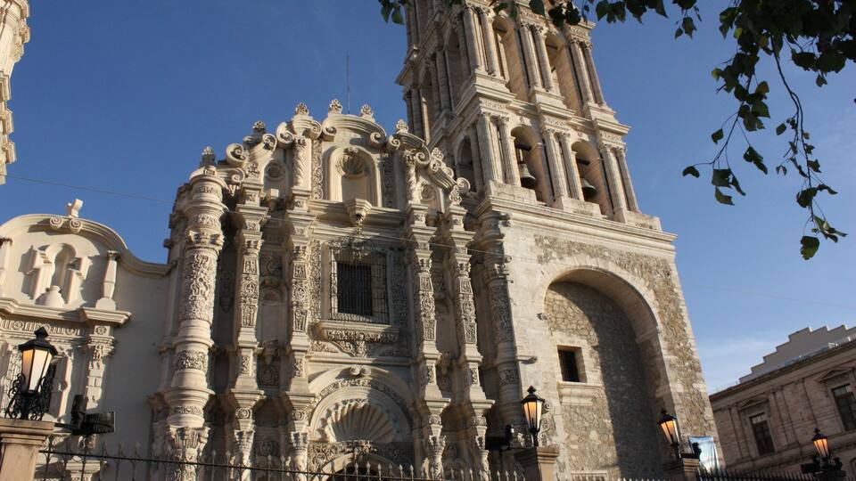 A historic church with ornate architecture, including a bell tower and detailed carvings.