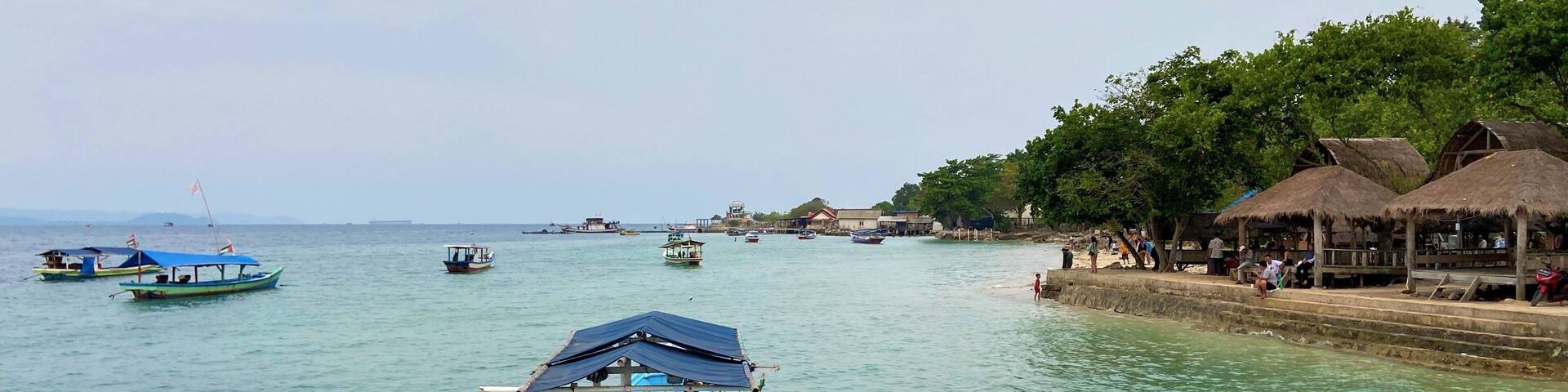 Bandar Lampung, Indonesia - September 1st 2024: Fishing boats are parked on the seashore in the afternoon with a cloudy sky in the background