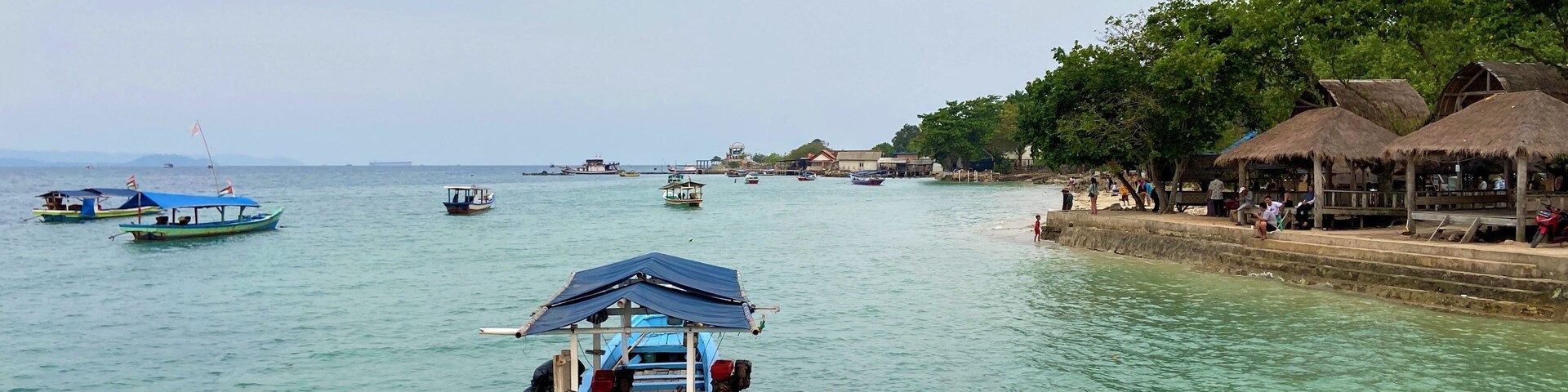 Bandar Lampung, Indonesia - September 1st 2024: Fishing boats are parked on the seashore in the afternoon with a cloudy sky in the background
