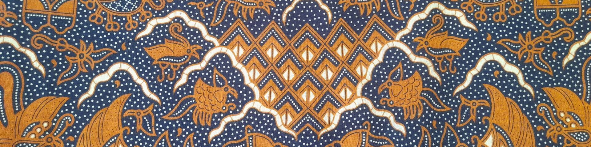 Traditional batik pattern with brown and navy blue tones featuring floral and animal motifs. Batik Cuwiri. Perfect for textile, background, cultural, and ethnic design projects.