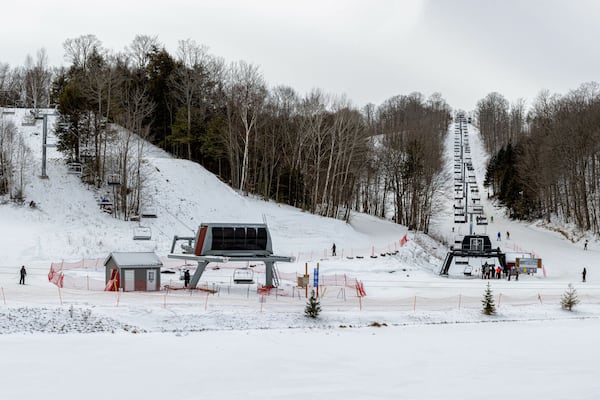 Skiers going down the slopes and taking the chairlift at Horseshoe ski resort in Barrie, Ontario, Canada