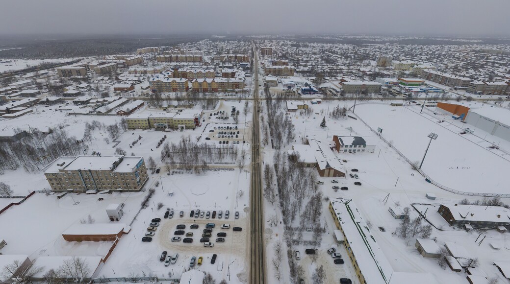 Sovetskiy city. Sports complex and stadium. Aerial. Winter, snow, cloudy. Khanty Mansiysk Autonomous Okrug (HMAO), Russia.
