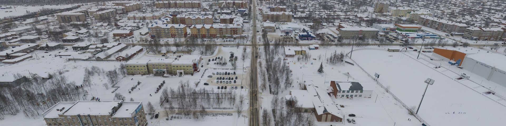 Sovetskiy city. Sports complex and stadium. Aerial. Winter, snow, cloudy. Khanty Mansiysk Autonomous Okrug (HMAO), Russia.