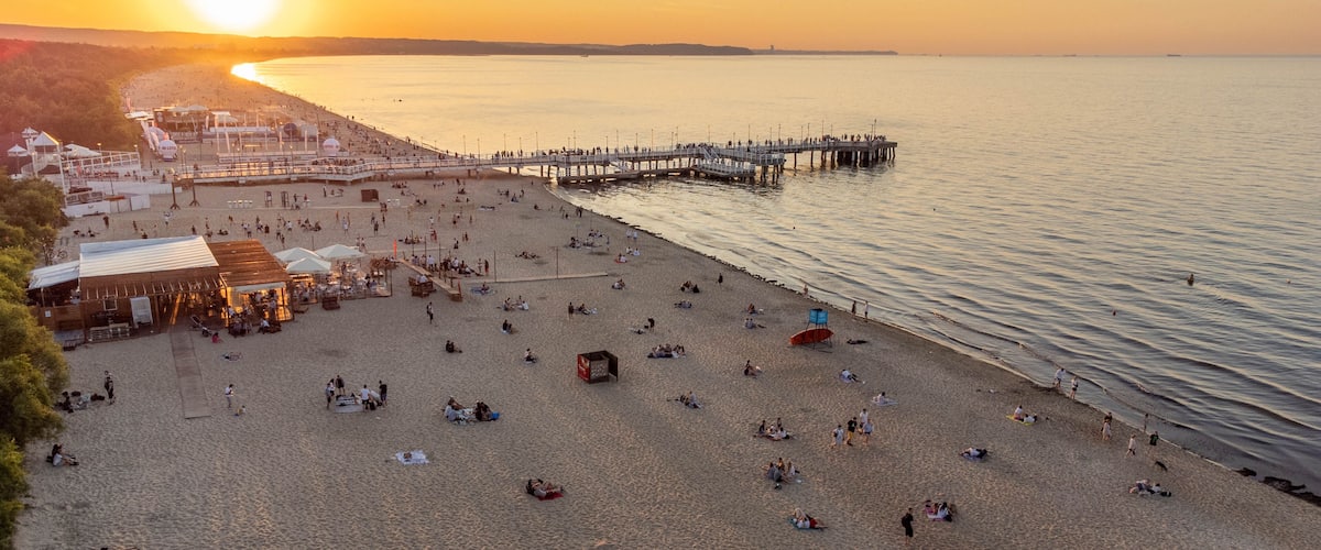View of the beach and pier in Brzeźno, Gdańsk at sunset. Summer 2022.