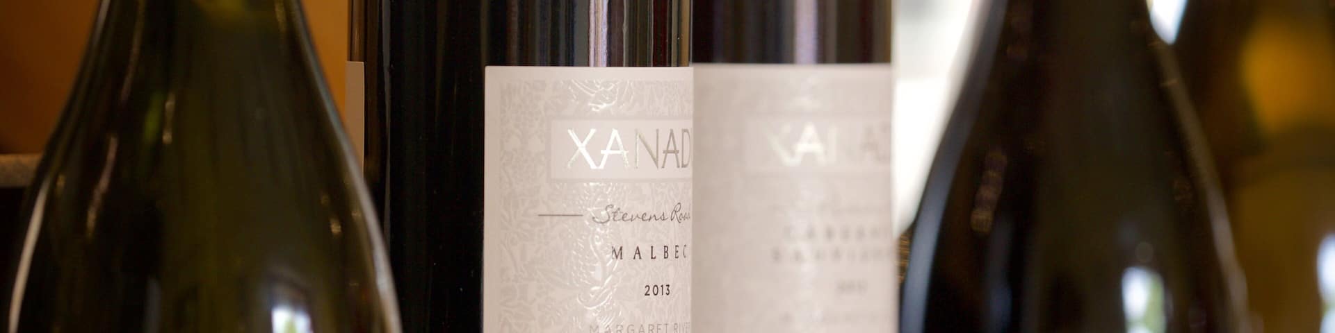 Several wine bottles with labels.