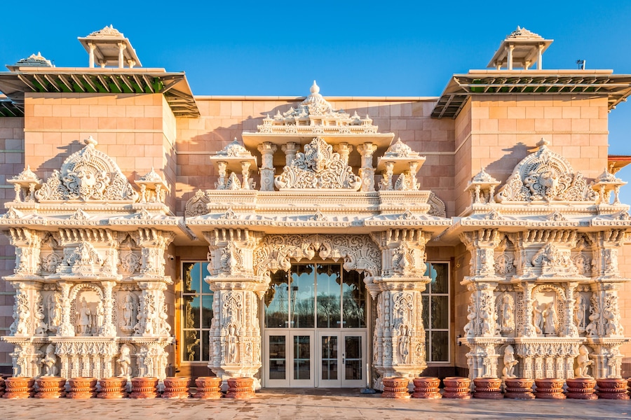 A temple with intricate carvings and a large arched entrance.