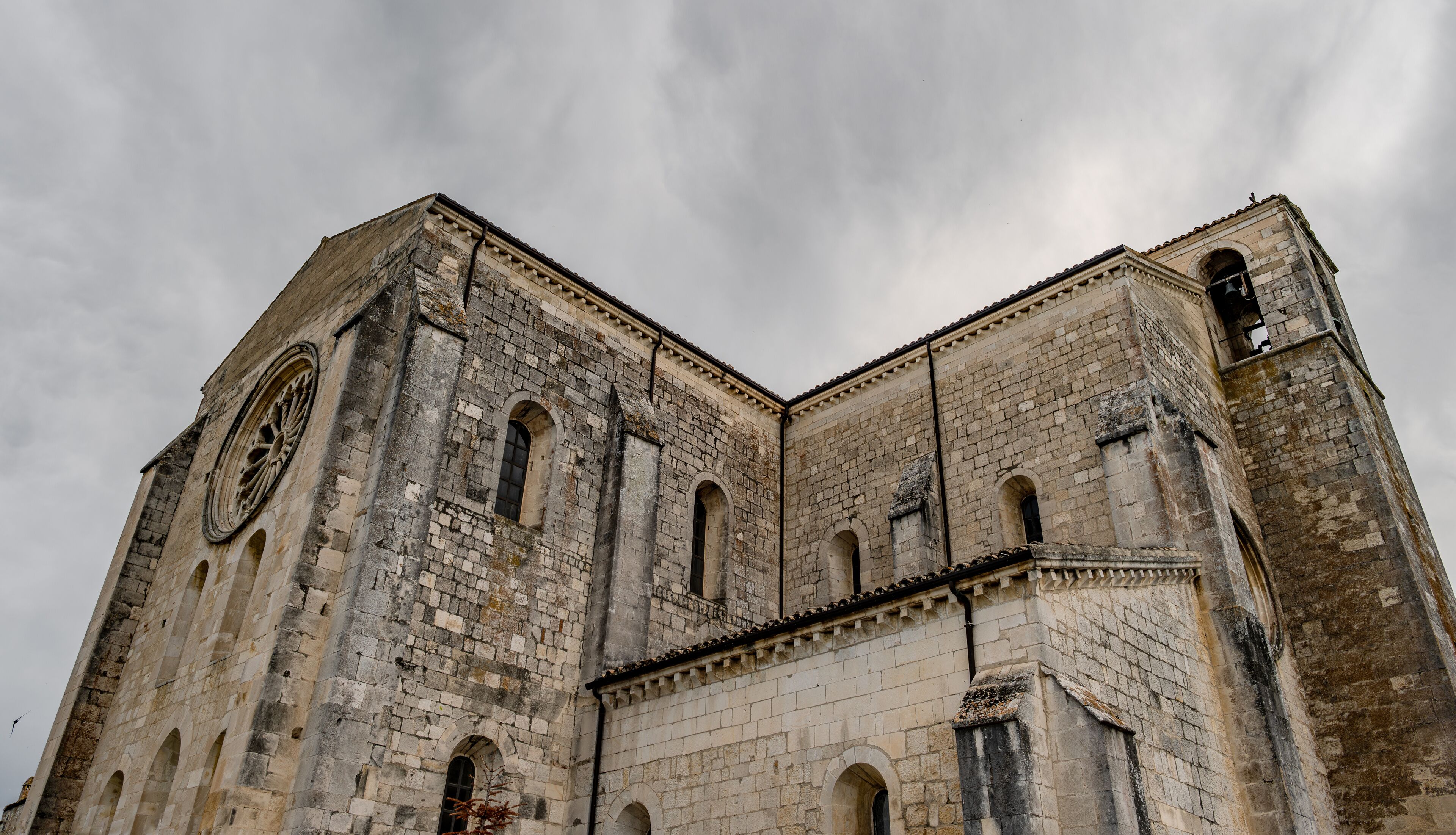 A historic stone church with arched windows and a bell tower.