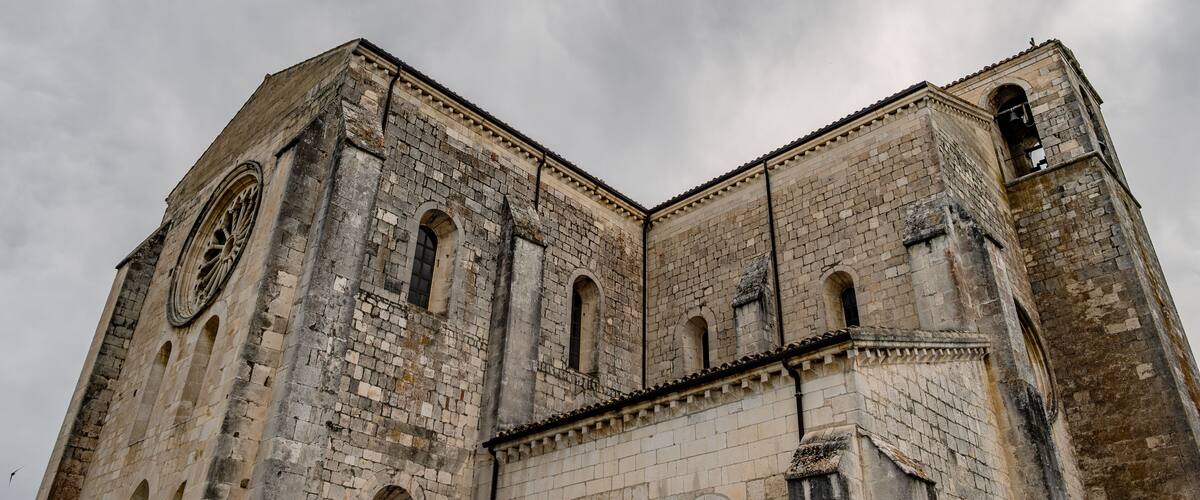 A historic stone church with arched windows and a bell tower.