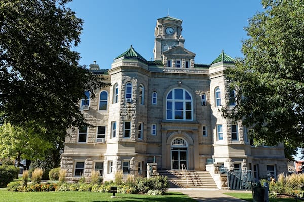 The Appanoose County Courthouse rises between the trees. This courthouse has served the county since 1904.