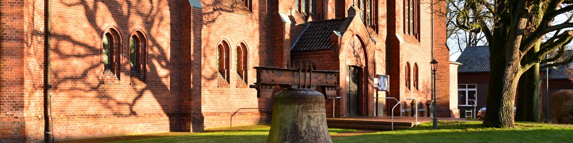 A red brick church with arched windows and a bell tower.