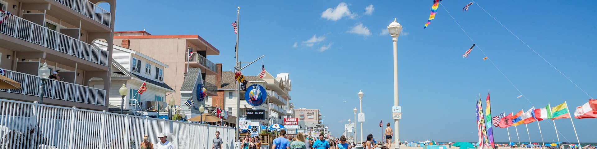 Ocean City Boardwalk which includes a sandy beach and street scenes