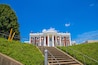 a staircase up a hill surrounded by lush green trees and plants with a red brick building on top at Hunter Museum of American Art in Chattanooga Tennessee USA