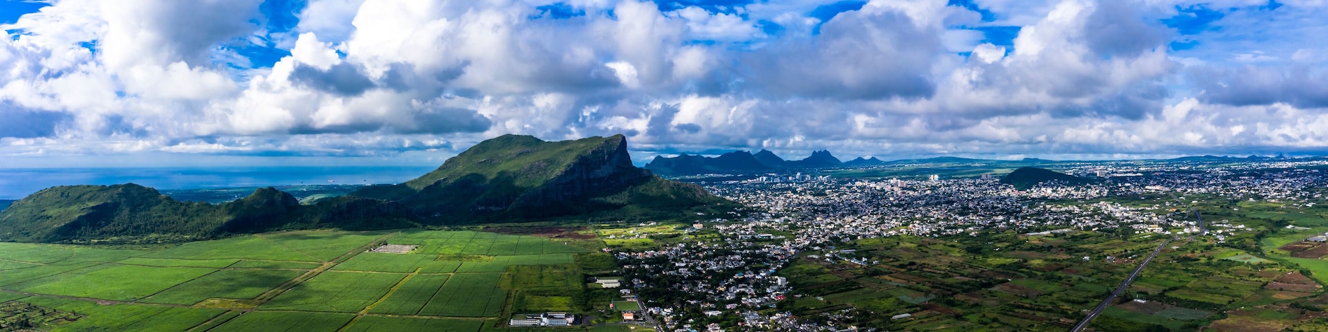 Mauritius, Black River, Flic-en-Flac, Helicopter view of island city with Corps de Garde mountain in background