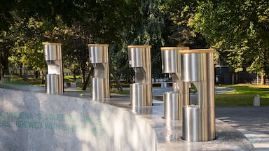 A memorial with stainless steel pillars and a commemorative plaque.