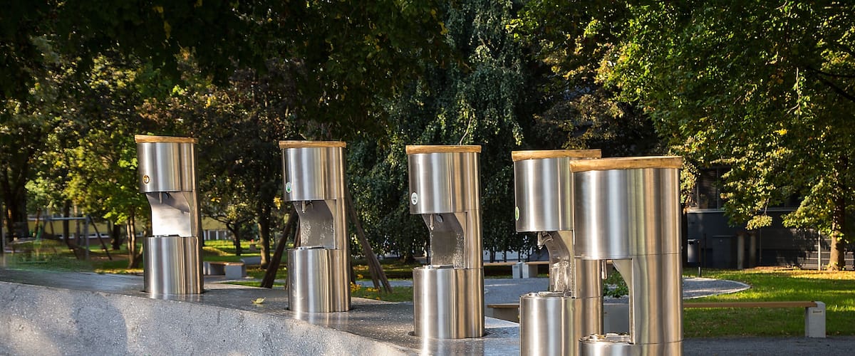 A memorial with stainless steel pillars and a commemorative plaque.