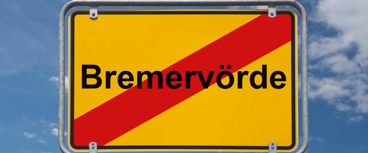 A road sign with the word "Bremervörde" against a blue sky with clouds.