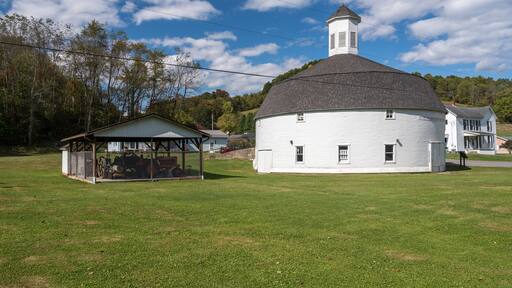 Well preserved white wooden round barn with cupola in Mannington, West Virginia