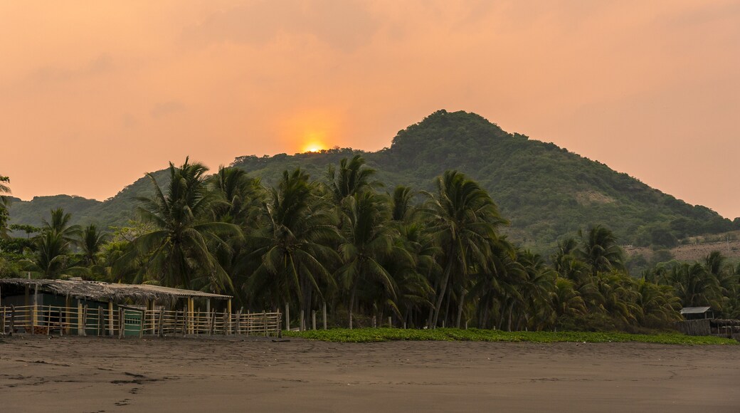 Sunset over lush greenery and beach at Mizata, El Salvador