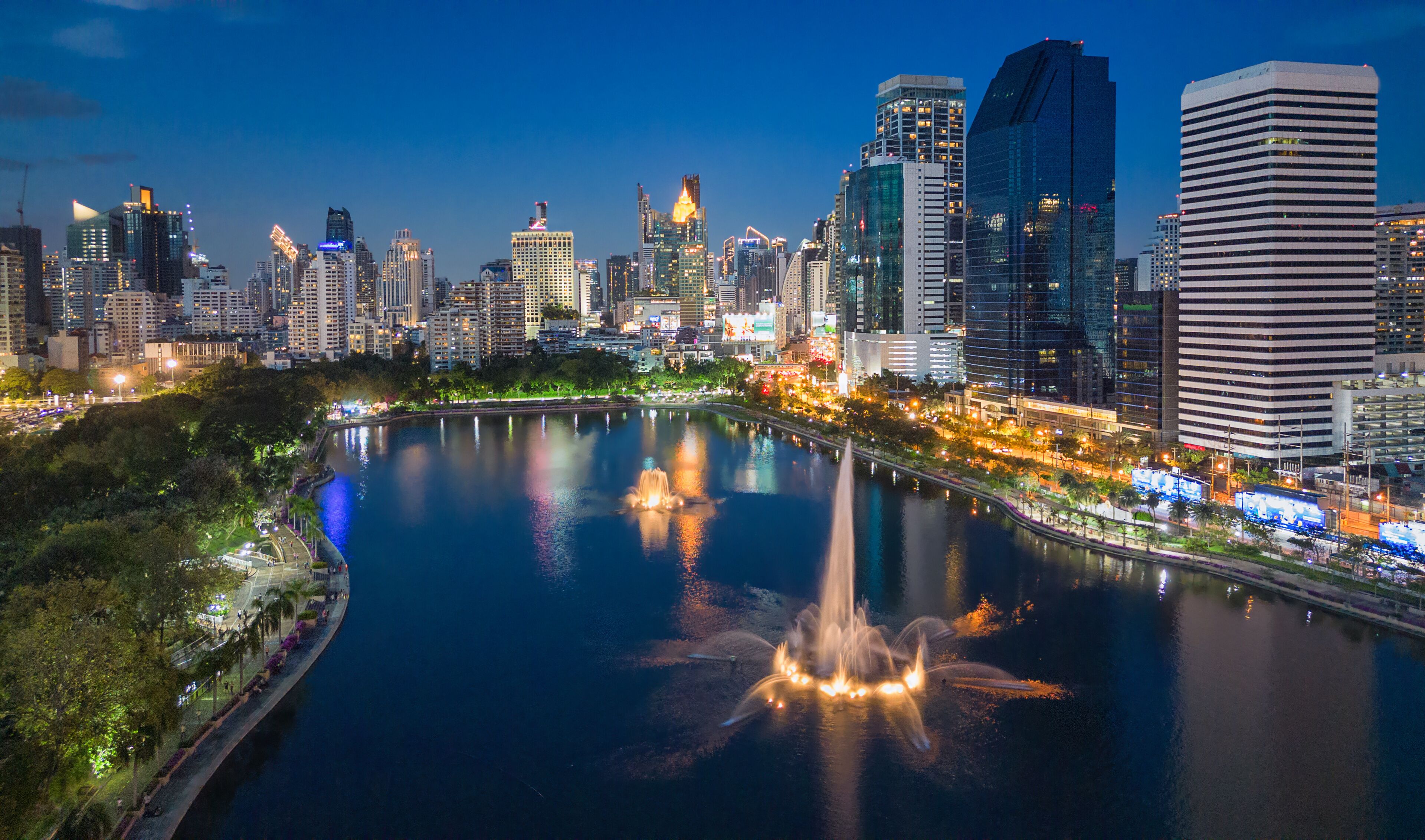 Aerial evening view from Benchakitti Park towards Asok in Bangkok, Thailand.