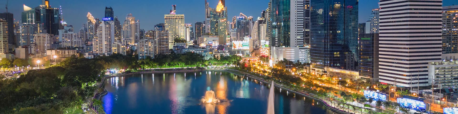 Aerial evening view from Benchakitti Park towards Asok in Bangkok, Thailand.