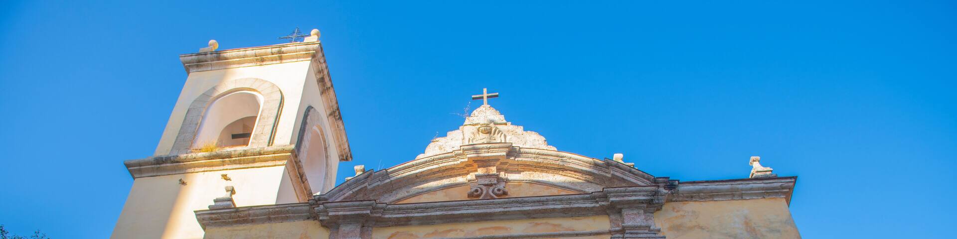 A church with a bell tower and a dome.