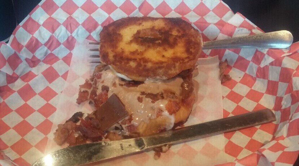 Fancy Grilled Cheese Donut!! Out of this freaking world!! This jam here is the Choco-Bacon Bliss. A glazed donut sliced in half and placed on the griddle forms the base of this sandwich. Then. it's filled with mozzarella, bacon, chocolate marscapone and pieces of a Hershey's chocolate bar!