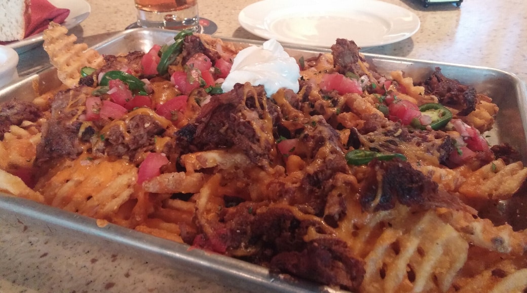 Waffle nachos!
Masa-crusted waffle fries topped with smoked pulled pork, cheddar cheese, salsa, jalapenos, cilantro and sour cream.