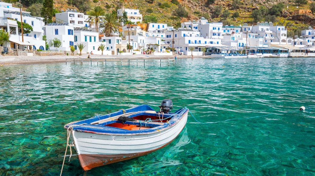 Fishing boat and the scenic greek village of Loutro in Crete, Greece