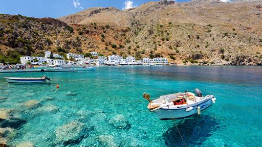 Small motorboat at clear water bay of Loutro town on Crete island, Greece