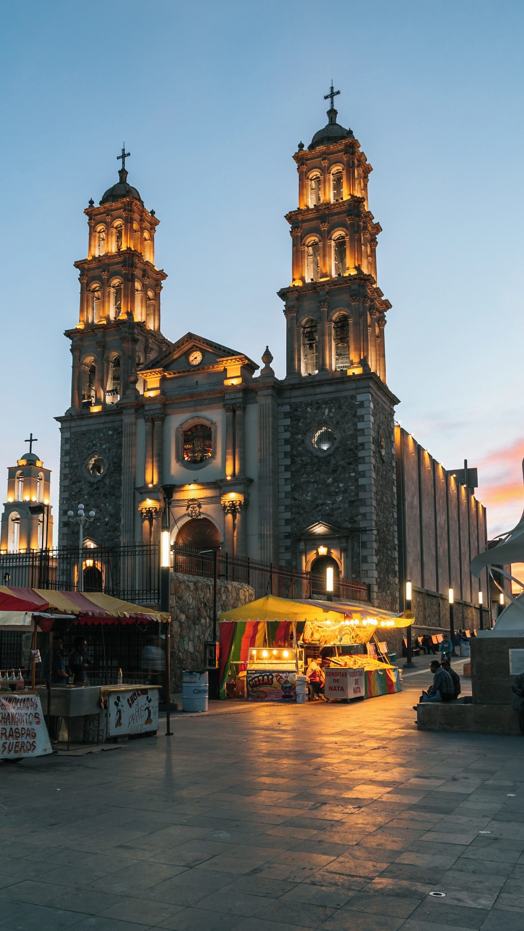 Cathedral of Our Lady of Guadalupe shines at twilight in Ciudad Juarez, showcasing its stunning architecture and vibrant atmosphere