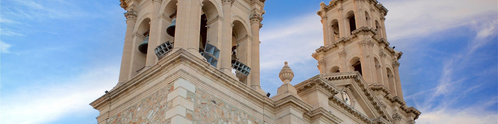 A historic church with two bell towers and a clock.